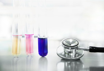 three test tube with stethoscope for medical doctor check up in science research laboratory background