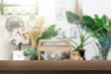 Empty wood table in front of blurred workplace background.