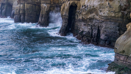 Waves hitting cliffs
