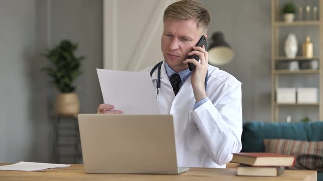 Doctor Talking on Phone with Patient, Discussing Treatment Plan