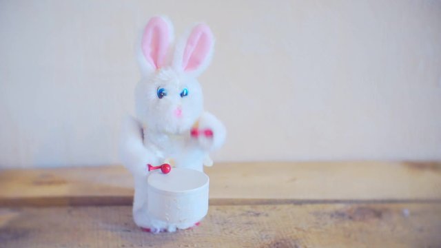 little furry toy rabbit knocks into the drum