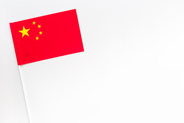 Chinese flag concept. small flag on white background top view copy space