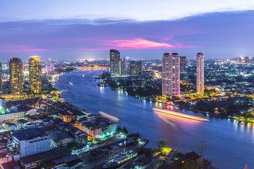 Aerial view of Bangkok City modern office buildings, condominium, hotel in Bangkok city downtown business and finance with Chao Phraya River during sunset sky, Bangkok, Thailand.