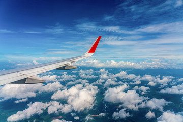 Wing of an airplane sky high cloud view 