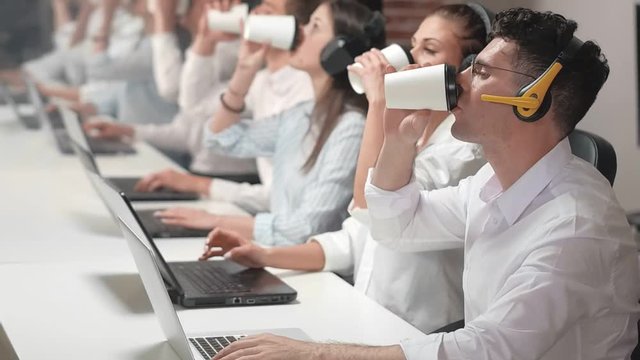 Sales employees consulting customers in office.