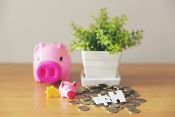 Piggy with coins on wooden table 