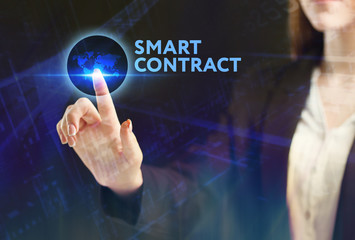 The concept of business, technology, the Internet and the network. A young entrepreneur working on a virtual screen of the future and sees the inscription: smart contract