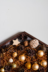 Christmas Background on a table of colored cones, beads, yellow,gold balls. New Year composition.pine cones and Christmas tree decorations on wooden background. Copy space.Selective focus