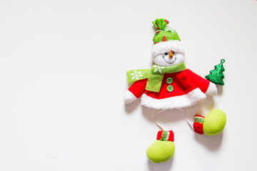 Fototapeta premium felt toy, snowman with christmas tree isolated on white.copy space. Christmas tree decor idea for children.Christmas decorations with Snowman toy and figures. Christmas and New Year concept
