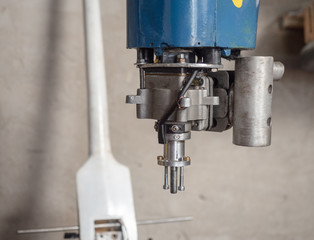 An old engine of the model airplane, close up. Power plant of vintage model aircraft and white machine part. Retro model diesel engine close up. Blurred background, soft selective focus