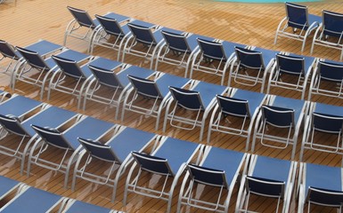 Lounge chairs lined up on a cruise ship deck
