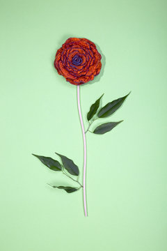 Brooche of fulled wool in the form of a flower on a green background