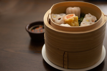 Variety of Dumplings in a Dim Sum Wooden Steamer
