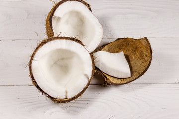 Fresh ripe coconut on white wooden table