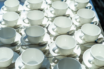 Abstract blurred many rows of coffee tea cups with coffee dispenser