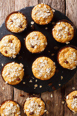 Dietary muffins from oat flakes with raisins and honey close-up. vertical top view from above
