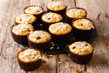 Organic food: oatmeal muffins with raisins close-up on a slate plate on a table. horizontal
