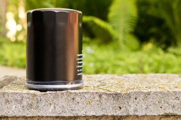 New car oil filter. Close up. On green background