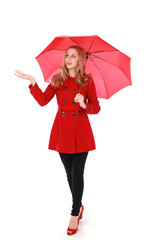 portrait of pretty blonde girl wearing red trench coat, holding an umbrella. full length standing pose. isolated on white studio background.