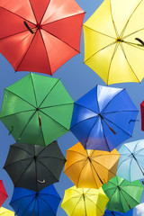 Colorful umbrellas on a blue sky background