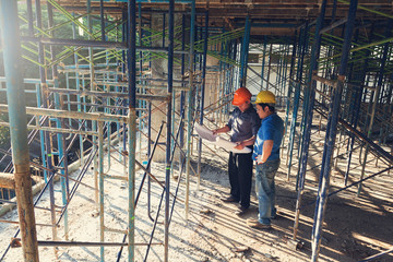 Construction concepts, Engineer and Architect working at Construction Site with blueprint