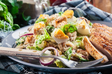 Healthy caesar salad with chicken, eggs and croutons