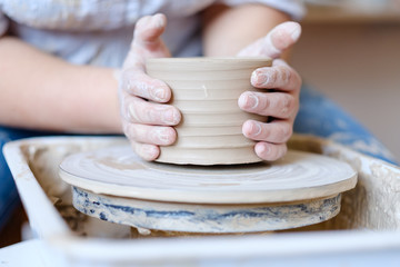 pottery workshop. handmade craft. artisan forming and shaping clay on potter wheel