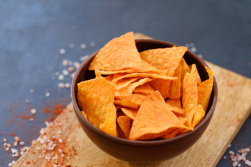 tortilla nacho chips recipe. natural fried crisps in a bowl on dark background