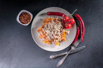 Penne pasta with tomato sauce, turkey minced meat, hot chilli and cherry tomatoes
