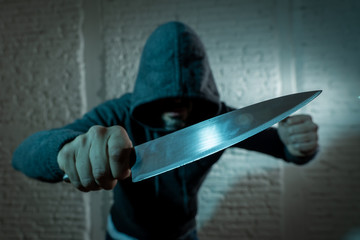 close up of man holding knife in knife crime concept photo