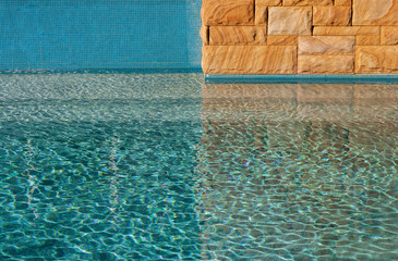 Sandstone wall against pool