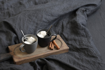 Two coffee mug in dark grey bed