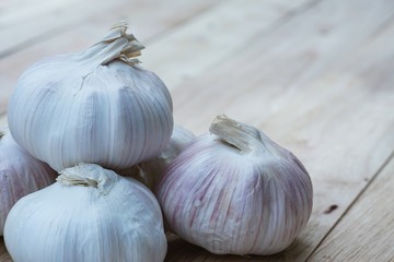 Fresh raw garlic on wooden table, copy space, kitchen raw ingredient concept