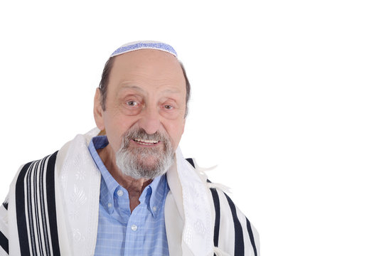 Eldery jewish man wrapped in talit praying