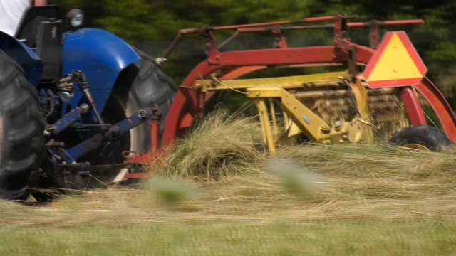 Close up of a rake on a tractor rowing hay