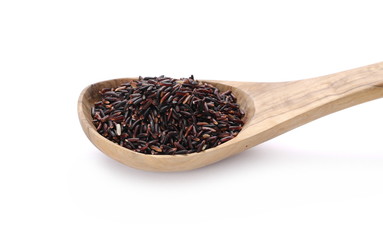 Organic black rice in wooden spoon isolated on white background   