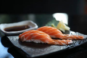 Salmon sushi on black plate japanese food