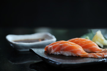 Salmon sushi on black plate japanese food