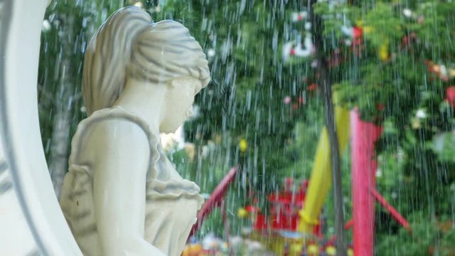 Fountain in summer garden. Ancient Greec person