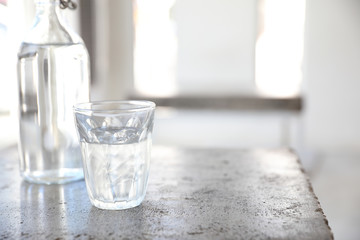 water in glass and bottle on table in coffee shop