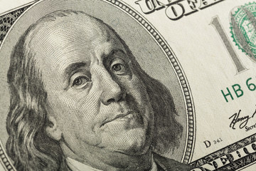 Macro shot of a 100 dollar. Dollars Closeup Concept. American Dollars Cash Money. One Hundred Dollar Banknotes. Hundred Bucks. Benjamin Franklin's portrait.