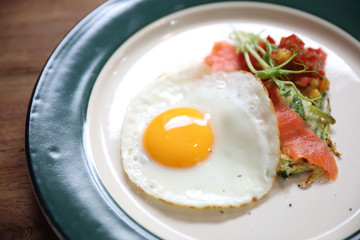 Zucchini fritters with egg on wood background vinage style