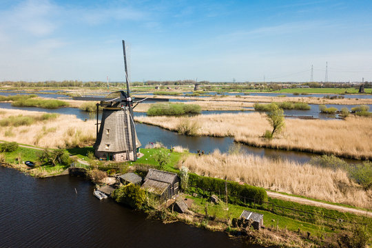 Aerial view of Netherlands rural landscape with windmills at fam