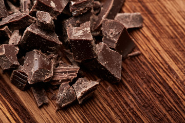 crumbs of black chocolate on a wooden background