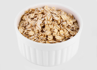 pile of oatmeal isolated on white background. Creative layout made of organic oatmeal isolated on white background. Food concept.