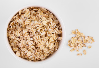 pile of oatmeal isolated on white background. Creative layout made of organic oatmeal isolated on white background. Food concept.