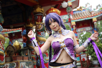Fototapeta na wymiar Portrait of asian young woman with purple Chinese dress cosplay with temple