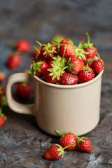 Fresh red strawberry on a dark abstract background. Summer berries. The concept of healthy eating.