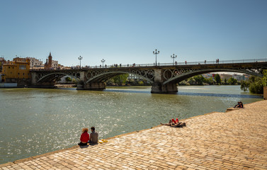 Triana Bridge in Seville, Spain. Exposure of the Triana Bridge in Seville, Spain, and the river...