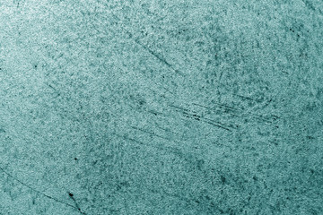 Grungy cement wall in cyan color.